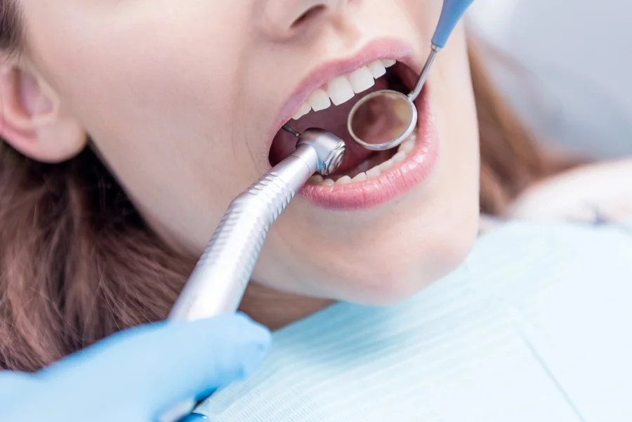 Dentist near me performing a close-up dental examination with a mirror